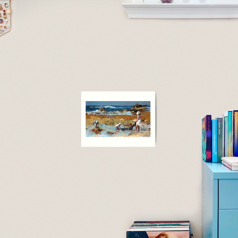 May include: A painting of three children playing on a beach. The children are wearing white clothing and are standing in the shallow water. The beach is sandy and there are rocks in the background. The sky is blue and there are clouds in the distance.
