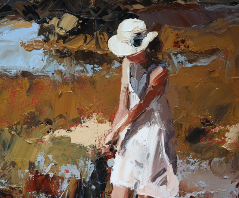 May include: A woman wearing a white dress and a white hat stands in a field of brown and green grass. The painting is done in a loose, impressionistic style.