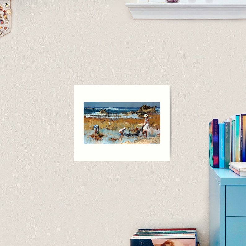 May include: A painting of a beach scene with three people in the foreground. The people are wearing white clothing and are standing in the shallow water. The water is a light blue color and the sand is a light brown color. The background is a blue sky with white clouds.
