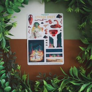 May include: A sticker sheet featuring illustrations of Medusa and related imagery. The sheet includes images of Medusa, snakes, Greek vases, and architectural elements. The text "MEDUSA STICKER SHEET" is at the top. The artist's website is at the bottom.