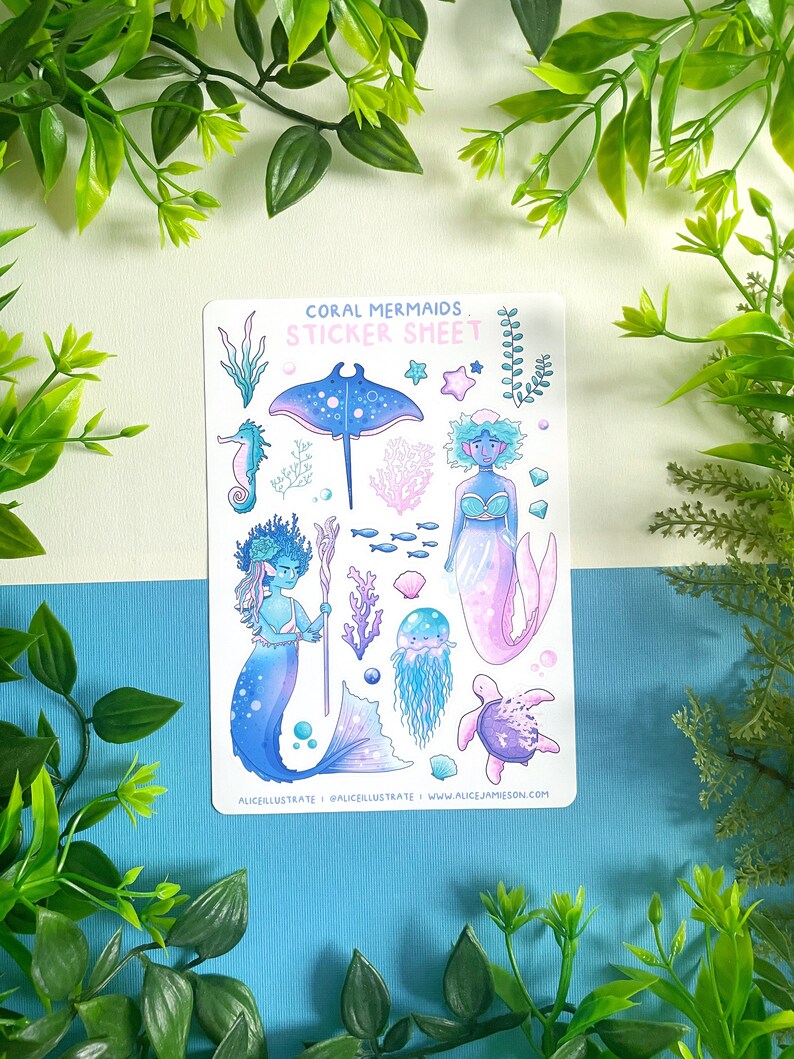 May include: A sticker sheet with illustrations of mermaids and marine life. The design includes a seahorse, stingray, jellyfish, and a turtle. The text "Coral Mermaids Sticker Sheet" is displayed at the top of the sheet.