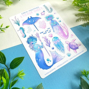 May include: A sticker sheet labelled "Coral Mermaids" with illustrations of mermaids and marine life. The mermaids are in blue and purple hues, with detailed fins and hair. Other sea creatures include a stingray, seahorse, and jellyfish, with coral accents.