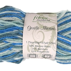 May include: A ball of Gentle Merino yarn in shades of blue, teal, and white. The label reads "fibra natura Gentle Merino" and lists the yarn's composition: 50% Merino Wool, 25% Bamboo, and 25% Polyamide. The ball weighs 1.75oz/50g and is 137yd/125m.