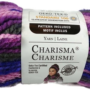 May include: A skein of Charisma brand yarn in shades of purple, blue, and gray. The label reads "Pattern Included" and "Yarn | Laine". The yarn is Oeko-Tex certified.