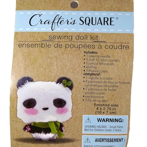 May include: A Crafter's Square sewing doll kit in brown packaging featuring a panda illustration. The kit includes a sewing needle, 4 craft fur panels, 5 felt panels, stuffing, and 3 thread colors. The finished size is 4 by 2.75 inches.