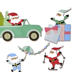 May include: A collection of Christmas-themed paper cutouts. Santa Claus figures are depicted in various scenes: driving a green truck with trees, standing atop gifts, holding an umbrella, and skiing. The cutouts feature red, green, blue, and white colors.