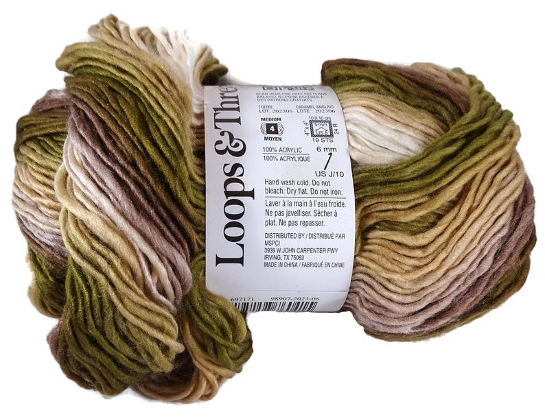 Puede incluir: Una madeja de hilo Loops & Threads de peso medio 4 con una paleta de colores variados en verde oliva, bronceado, marr&oacute;n y crema. La etiqueta de papel blanco muestra detalles del producto, incluyendo 100% acr&iacute;lico y un tama&ntilde;o de 6 mm.