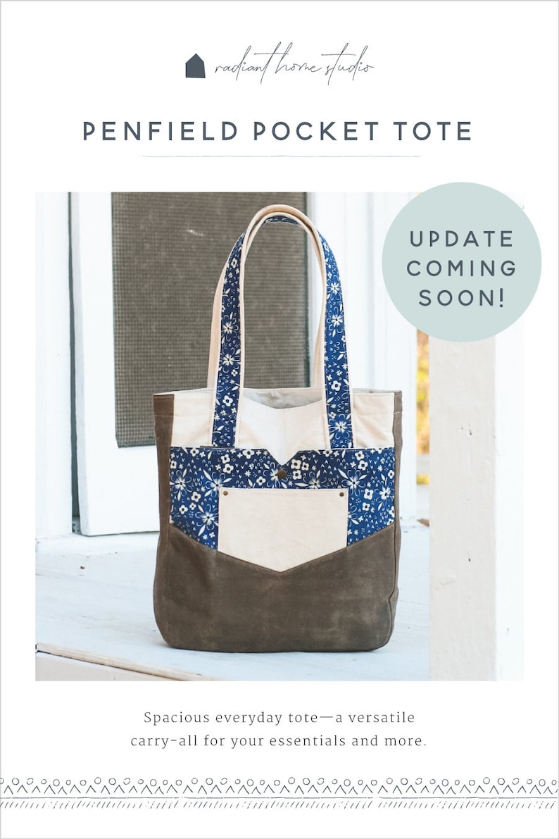 May include: The Penfield Pocket Tote bag features a brown suede-like bottom, a cream-colored pocket, and a blue floral patterned top. The tote has cream-colored handles and the text "UPDATE COMING SOON!" in a circle.