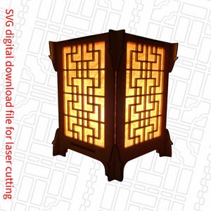 May include: A wooden lamp with a geometric design and a warm, glowing light. The lamp is made of laser-cut wood and has a square base.