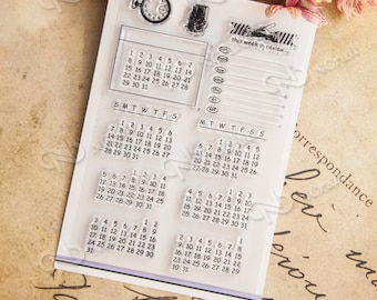 May include: Clear stamps with calendar grids and the text "this week in review..."  The stamps are designed for scrapbooking, journaling, and card making.