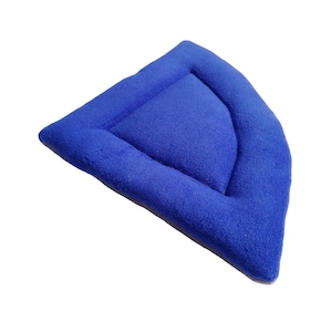 May include: A blue, crescent-shaped pet bed made from soft, plush fabric.
