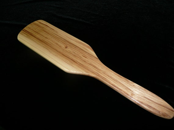 Unique wood spanking paddle with shark's tooth blade