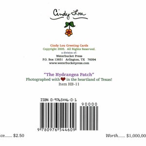 May include: A greeting card with the text "Cindy Lou" at the top, featuring a floral design. The card includes the title "The Hydrangea Patch" and copyright information. A barcode and ISBN are also visible.
