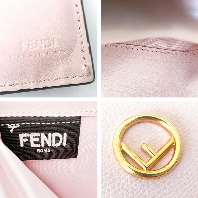 May include: A pink leather wallet with a gold Fendi logo and the text "Fendi Roma" on the inside. The wallet also has the text "Fendi Made in Italy" on the outside.