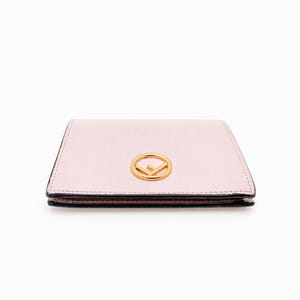May include: A pale pink leather wallet with a gold Fendi logo.