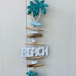 Carved and painted palm trees and word beach on a seagrass rope with driftwood and stone, 30&quot;x6&quot;