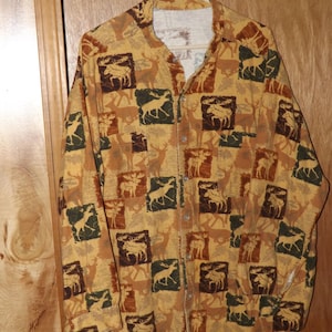 May include: A long-sleeved button-up shirt with a brown, green, and tan moose print.