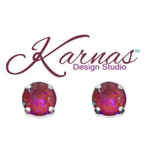May include: A pair of silver stud earrings with round, iridescent red gemstones.