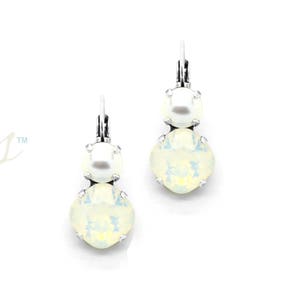 May include: A pair of silver dangle earrings with a white opal and pearl drop. The earrings are designed with a single pearl at the top and a larger opal stone below.