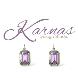 May include: A pair of silver earrings with a light purple emerald-cut crystal. The earrings have a silver hook closure. The crystals have a light green iridescent sheen.