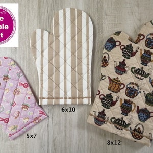 May include: Three quilted oven mitts in different sizes. One is lavender with a pattern of desserts, one is beige with vertical stripes, and the largest is beige with a teapot pattern. The Purple Hat logo is in the upper left.