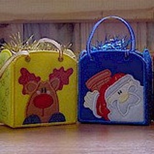May include: Four square felt gift bags with handles, each featuring a holiday character: a green bag with a penguin, a yellow bag with a reindeer, a blue bag with Santa Claus, and a red bag with a snowman. Each bag is filled with metallic tinsel.