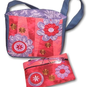 May include: A floral tote bag and glasses case set. The tote bag has a pink and red striped pattern with large purple and red flower appliqués. The glasses case matches the design. Both items feature embroidered floral details and blue accents.