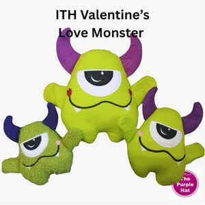 May include: Three plush monster toys with the text ITH Valentine's Love Monster. The monsters are lime green with purple horns, one large eye, and a wide mouth with small white teeth. The smallest monster has a textured, fuzzy green fabric.