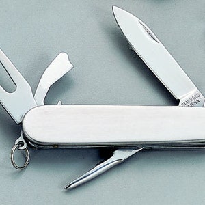 May include: A silver multi-tool pocket knife with a variety of blades and tools, including a bottle opener, a screwdriver, and a golf tool. The knife is closed and has a silver handle with the words "Stainless China" printed on it.