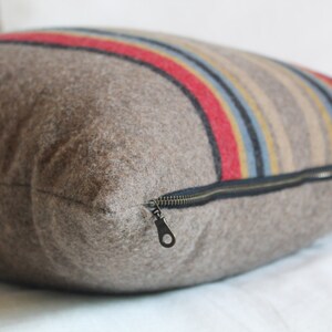 Yakima Camp Stripe Merino Wool Pillow Cover in Mineral Umber by True Having • Shown in 18"x18" size, close-up image of zipper
