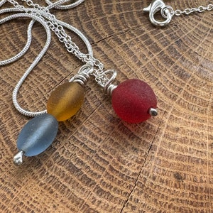 seabead silver necklace. Choose red single. yellow blue double. seaglass necklace. spinner image 4