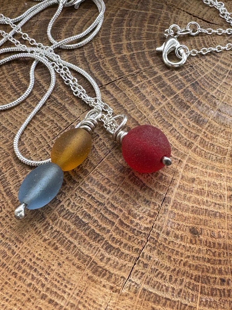 seabead silver necklace. Choose red single. yellow blue double. seaglass necklace. spinner image 4