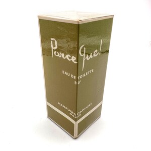 May include: A rectangular olive green perfume box with white text that reads Parce Que! EAU DE TOILETTE 80° and PARFUMS CAPUCCI PARIS. The packaging features a clean, vertical design with white borders and a glossy finish on the exterior surface.