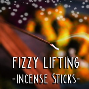 May include: A close-up of a smoldering incense stick with a white tip, emitting a wisp of smoke. The text "FIZZY LIFTING - INCENSE STICKS -" is visible in the foreground.