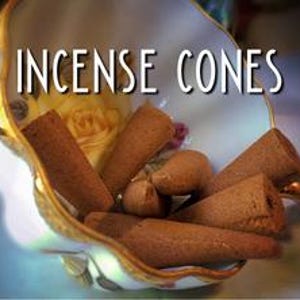 A bowl filled with brown incense cones sits on a table, with the text "INCIENSE CONES" displayed above it.