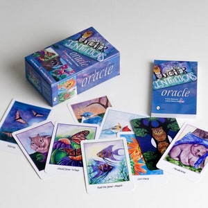 An oracle deck box, book, and sampling of included cards. The box is mostly blue-violet with Higher Intuitions Oracle on the front. Cards include images of bear, owls, angelfish, butterflies, chipmunk, bats, cardinals, bluebird, and bats.