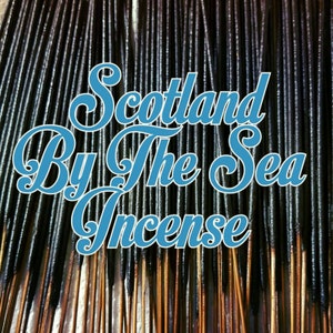 May include: A close-up of a bundle of black incense sticks with the text "Scotland By The Sea Incense" in blue lettering.
