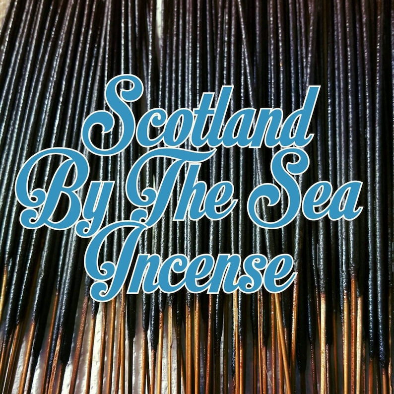 May include: A close-up of a bundle of black incense sticks with the text "Scotland By The Sea Incense" in blue lettering.