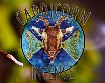 May include: A blue and green circle with a goat head in the center. The goat has brown fur and a white face. The circle has the words "CAPRICORN INCENSE" around it.