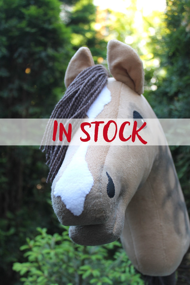 May include: A brown and white horse head plush toy with a brown mane. The toy is in stock.