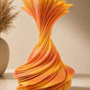 May include: A decorative vase with a unique, swirling design. The vase is made of layered, fan-shaped elements in shades of orange and yellow. The vase has a wide base that tapers to a narrow neck, and then flares out at the top.