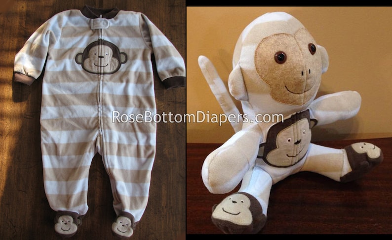 May include: A beige and white striped baby sleeper with a monkey face applique. The sleeper has a zipper closure and monkey face appliques on the feet. A stuffed monkey toy with a similar design is also shown.