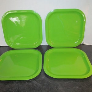 May include: Set of four square green plastic serving trays. The trays are a bright, vibrant green color and have a slightly rounded edge.