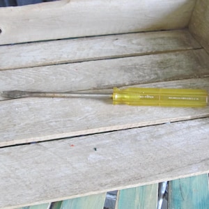 May include: A yellow screwdriver with a metal shaft and a black handle. The screwdriver is labeled "No-Fiter" and "Williams Hardware Co. U.S.A."