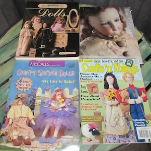 May include: Four craft books with colorful covers featuring dolls and crafts. The books are titled "Dolls", "Doll Costumes", "Country Garden Dolls", and "Crafts 'n Things".