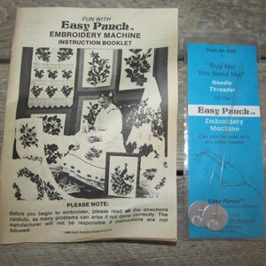 May include: A black and white instruction booklet for an Easy Punch Embroidery Machine. The booklet features a photo of a woman using the machine and several examples of embroidery designs. The booklet also includes a note about reading all directions carefully. A separate package contains a needle threader for the Easy Punch Embroidery Machine. The package is blue and white and includes the text "Buy Me! You Need Me!" and "Easy Punch Embroidery Machine".