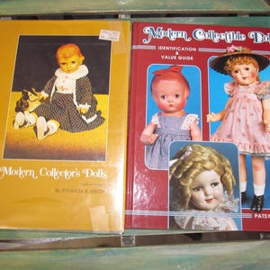 May include: Two books about modern collectible dolls. The book on the left is titled "Modern Collector's Dolls" by Patricia E. Smith. The book on the right is titled "Modern Collectible Dolls" with the subtitle "Identification & Value Guide" by Patsy Moyer.