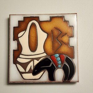 May include: A square ceramic tile with a Southwestern design. The tile features a brown and white pottery design with a black and red animal figure. The tile has a white background.