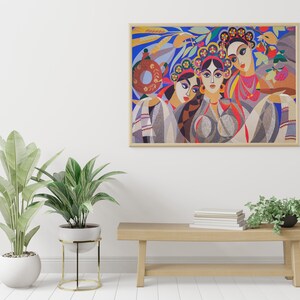 May include: A framed painting depicting three women wearing colourful clothing and floral headbands. The women are standing in front of a blue background with green leaves and flowers. The painting is in a wooden frame.