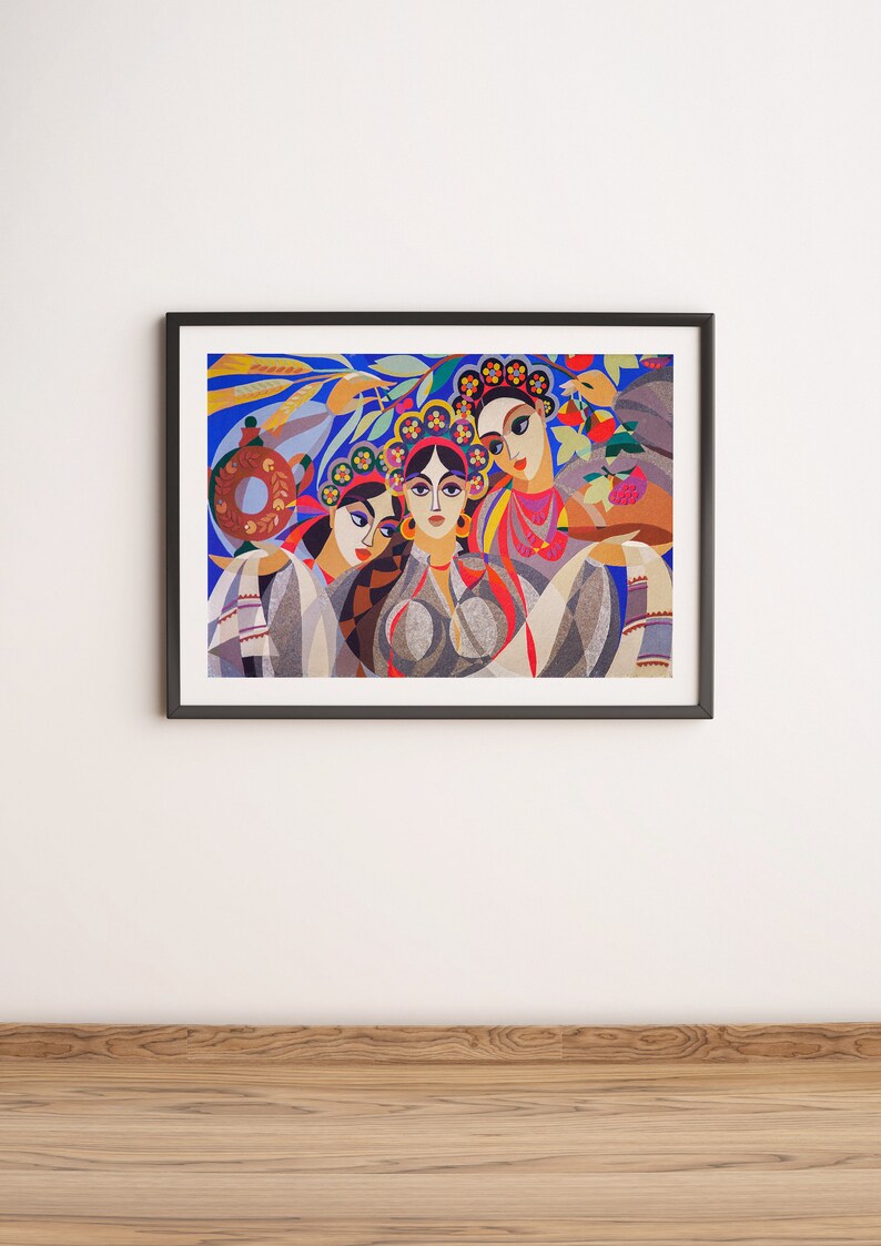 May include: A framed painting depicting three women wearing colourful headbands and traditional clothing. The women are portrayed in a stylised, geometric style against a blue background with floral accents.